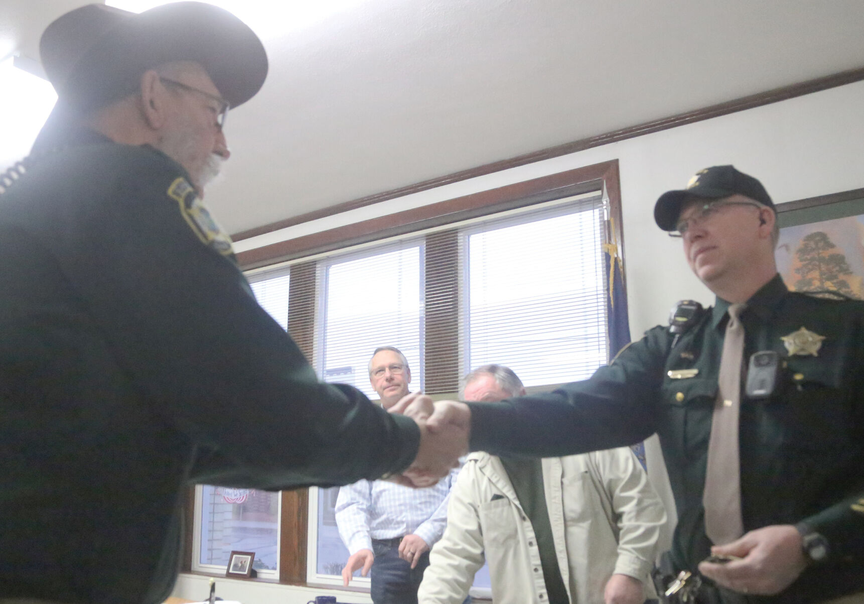 Commisioners Meeting badge handoff.jpg
